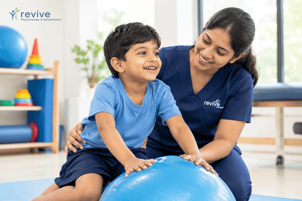 Physiotherapist assisting child with balance and flexibility exercises on exercise ball at Revive Clinic
